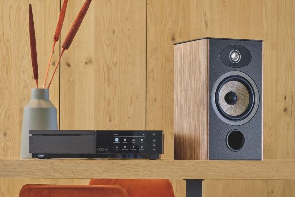 Control4 Touch panel in a able with a traditional home in the background